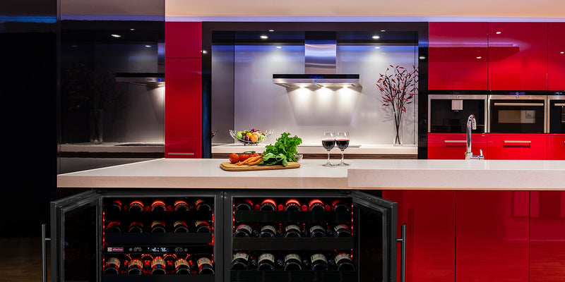A handsome black wine fridge compliments a stylish red kitchen