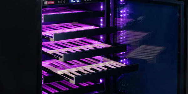Vibrant violet light emanates from the open door of a wine cooler
