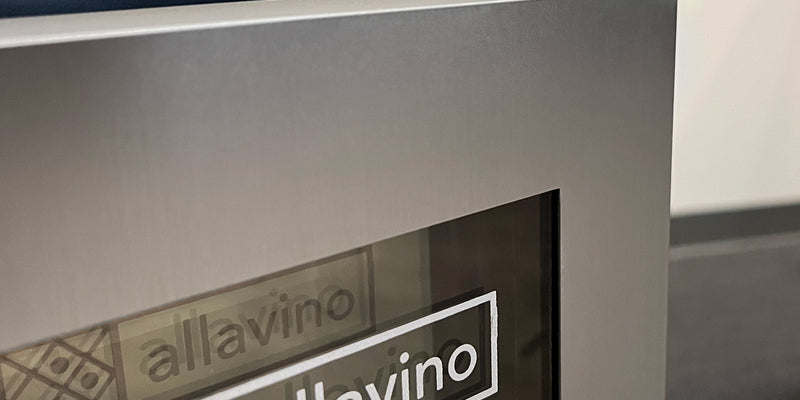 The Allavino logo in the corner of a stainless steel fridge door